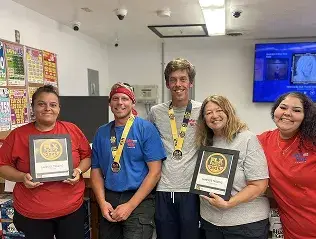 Lakeside Trading team holding awards and medals