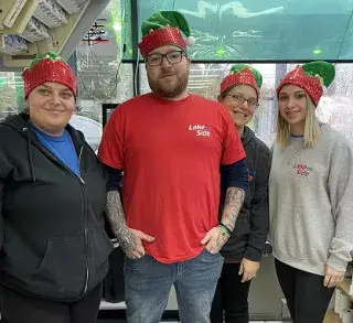 Lakeside Trading team members wearing holiday hats in store